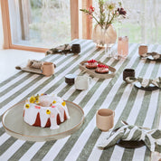 OYOY Living Design Striped Tablecloth in organic cotton with bold striped pattern. Available in multiple colors and sizes (200 × 140 cm or 260 × 140 cm).