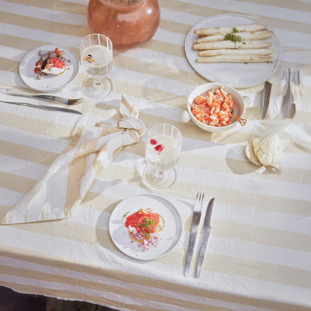 OYOY Living Design Striped Tablecloth in organic cotton with bold striped pattern. Available in multiple colors and sizes (200 × 140 cm or 260 × 140 cm).