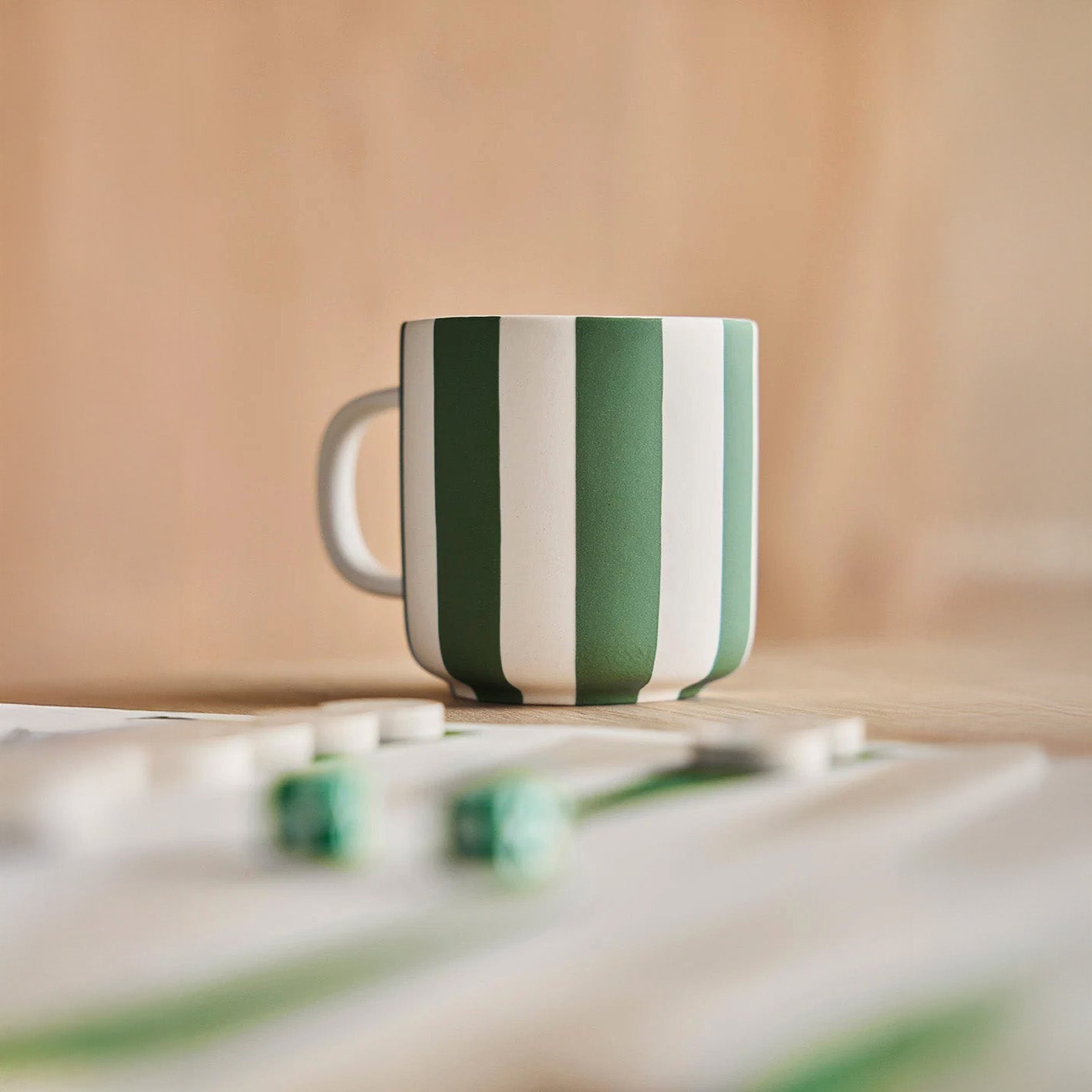 Toppu Mug by OYOY Living Design in hand-painted stoneware stripes, handmade and dishwasher safe, available in multiple colors.