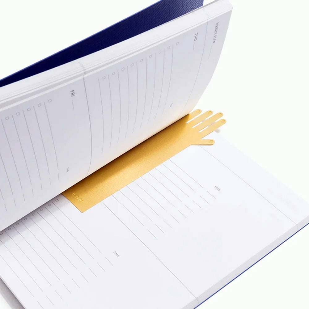 Poketo Brass Hand Bookmark, polished golden hand-shaped page marker. Durable and stylish gift for readers and design lovers.