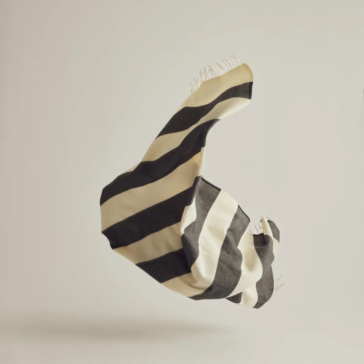 Silleben Sweater Throw in black 100% combed wool with tone-on-tone stripes.