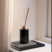 Skandinavisk Koto 200ml scent diffuser in painted glass bottle with wooden ring and reeds.