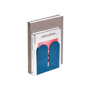 Tortuga Forma Large Bookend in abyss blue solid steel, oversized arc design for supporting heavy art books, cookbooks, and vinyl.