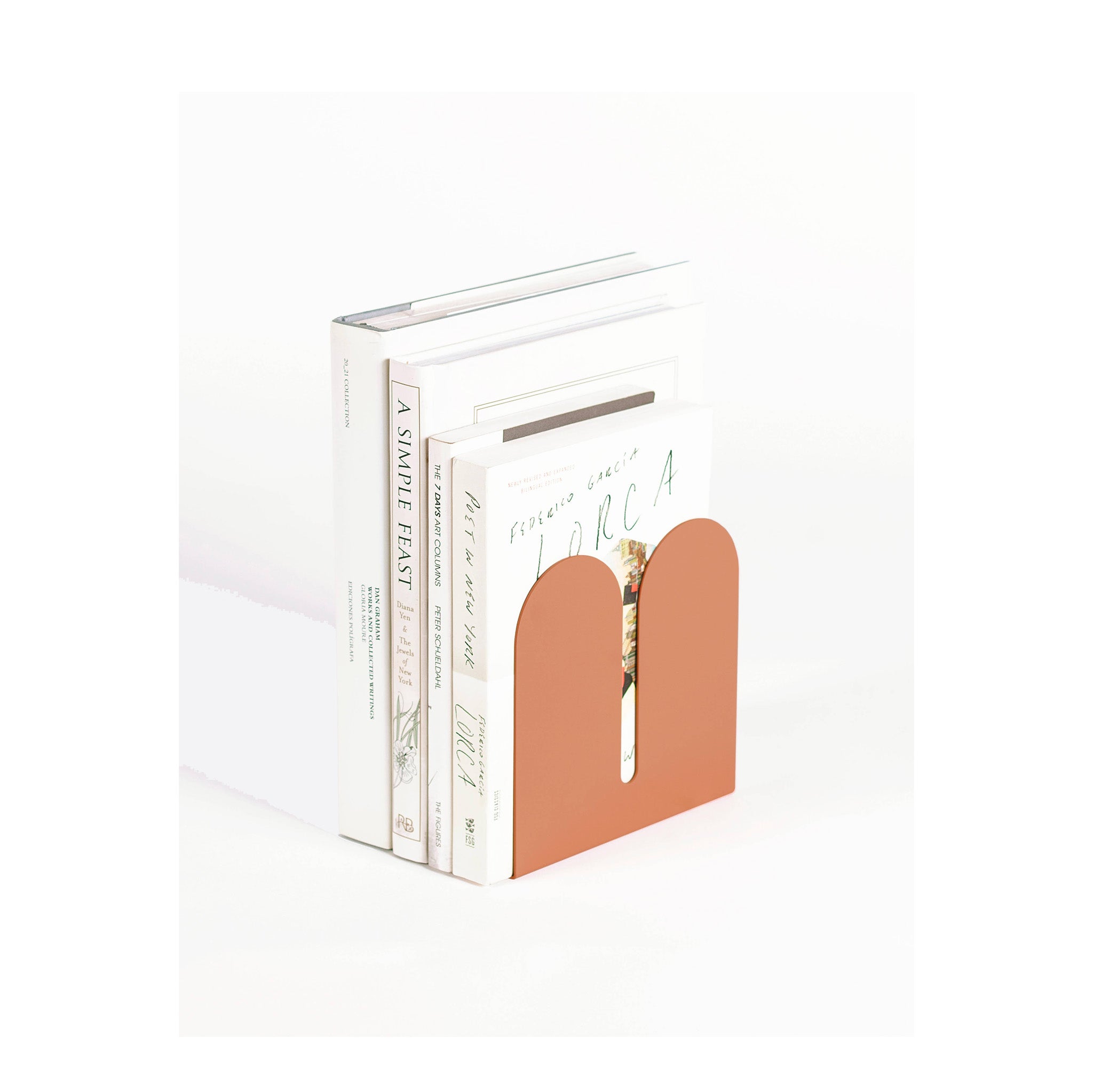 Tortuga Forma Coral Bookend, solid steel arc design for holding cookbooks, magazines, and novels.