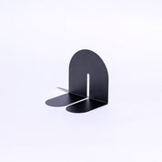 Tortuga Forma Graphite Bookend, solid steel arc design for supporting cookbooks, magazines, and novels.