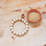 Verso Design KRANSSI Wreath Trivet in Birch with Leather loop, handcrafted Nordic bead design, usable as wreath or trivet.