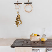 Verso Design KRANSSI Wreath Trivet in Birch with Leather loop, handcrafted Nordic bead design, usable as wreath or trivet.