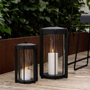 Firefly Lantern in powder-coated steel with glass sides and silicone strap by Zone Denmark. Available in two sizes: 25 cm and 35 cm.