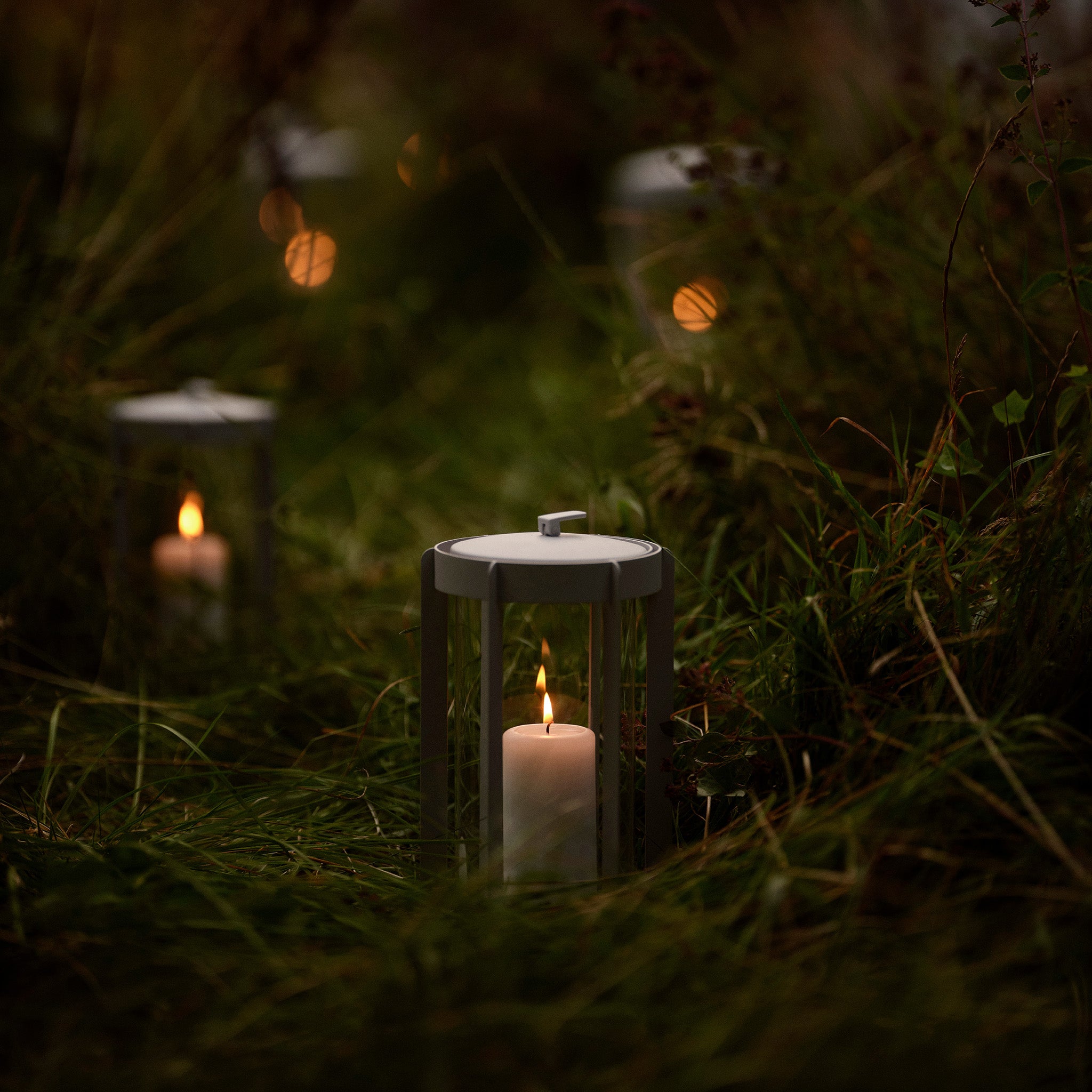 Firefly Lantern in powder-coated steel with glass sides and silicone strap by Zone Denmark. Available in two sizes: 25 cm and 35 cm.